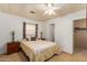 Bedroom with a queen-size bed, nightstands, and ceiling fan at 8266 E Pueblo Ave, Mesa, AZ 85208