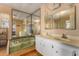 Bathroom with double vanity, large mirror, and a bathtub at 8266 E Pueblo Ave, Mesa, AZ 85208