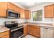 Kitchen with wood cabinets and stainless steel appliances at 15818 N 25Th St # 112, Phoenix, AZ 85032