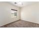 Simple bedroom with carpet flooring and a window offering natural light at 15818 N 25Th St # 112, Phoenix, AZ 85032