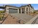 Gray-toned home with a brick facade and a paved driveway at 1165 E Gleneagle Dr, Chandler, AZ 85249