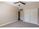 Bedroom with ceiling fan, double-door closet, and carpet flooring at 5335 E Shea Blvd # 1042, Scottsdale, AZ 85254