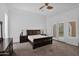 Spacious bedroom with a dark wood sleigh bed and french doors at 17903 W Solano Dr, Litchfield Park, AZ 85340