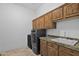 Laundry room with cabinets and granite countertop at 17903 W Solano Dr, Litchfield Park, AZ 85340