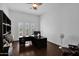 Home office with built-in shelving and hardwood floors at 17903 W Solano Dr, Litchfield Park, AZ 85340