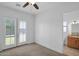 Bright bedroom with double doors leading to backyard at 17903 W Solano Dr, Litchfield Park, AZ 85340