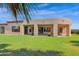Spacious backyard with grassy lawn, covered patio, and mature trees at 17903 W Solano Dr, Litchfield Park, AZ 85340