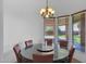Bright dining room with a round table and six chairs, overlooking the backyard at 17903 W Solano Dr, Litchfield Park, AZ 85340
