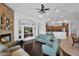 Open living room with a fireplace, views to the kitchen, and ample seating at 17903 W Solano Dr, Litchfield Park, AZ 85340