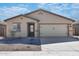 New single-story home with two-car garage and desert landscaping at 24594 W St Catherine Ave, Buckeye, AZ 85326