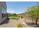 Landscaped backyard with artificial turf and desert landscaping at 156 E Leverenz Ave, San Tan Valley, AZ 85140