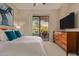 Spacious bedroom with private balcony access and a large TV at 2989 N 44Th St # 3036, Phoenix, AZ 85018