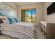 Comfortable bedroom with striped bedding and large window at 2989 N 44Th St # 3036, Phoenix, AZ 85018