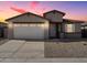 Two-story house with a two-car garage, landscaping, and a light-colored exterior at 37287 W Patterson St, Maricopa, AZ 85138