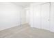 Bright bedroom with double-door closet and carpet at 37287 W Patterson St, Maricopa, AZ 85138