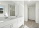 Double vanity bathroom with modern white cabinets at 37287 W Patterson St, Maricopa, AZ 85138