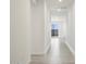 Bright hallway with tiled floors and a view of a backyard at 37287 W Patterson St, Maricopa, AZ 85138