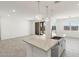 Kitchen island with granite countertop and sink at 37287 W Patterson St, Maricopa, AZ 85138