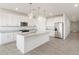Modern kitchen with white cabinets, granite counters, and island at 37287 W Patterson St, Maricopa, AZ 85138
