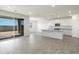 Bright kitchen with island, stainless steel appliances, and white cabinets at 37287 W Patterson St, Maricopa, AZ 85138