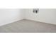 Simple bedroom with gray carpet and a window at 37287 W Patterson St, Maricopa, AZ 85138