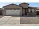 Two-story house with a two-car garage, landscaping, and a light-colored exterior at 37287 W Patterson St, Maricopa, AZ 85138