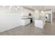 Open concept kitchen with island and chandelier, white cabinets at 37287 W Patterson St, Maricopa, AZ 85138