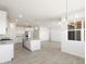 Modern kitchen with large island, white cabinets, and stainless steel appliances at 37287 W Patterson St, Maricopa, AZ 85138
