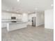 Modern kitchen with a large island, white cabinets, and stainless steel appliances at 37287 W Patterson St, Maricopa, AZ 85138