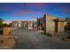 Stunning modern home with stone accents and a paved driveway at 10249 E Joy Ranch Rd, Scottsdale, AZ 85262