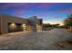 Modern two-car garage with paver driveway, showcasing contemporary design at 10249 E Joy Ranch Rd, Scottsdale, AZ 85262
