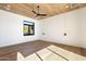 Bright bedroom featuring wood ceiling, large window, and hardwood floors at 10249 E Joy Ranch Rd, Scottsdale, AZ 85262