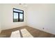 Light-filled bedroom featuring hardwood floors and large window at 10249 E Joy Ranch Rd, Scottsdale, AZ 85262