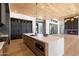 Open kitchen with island, stainless steel appliances, and wood flooring at 10249 E Joy Ranch Rd, Scottsdale, AZ 85262