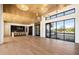 Open floor plan great room with high ceilings, hardwood floors, and large windows at 10249 E Joy Ranch Rd, Scottsdale, AZ 85262