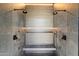 Spa-like shower with dual shower heads, built-in bench, and gray tile at 10249 E Joy Ranch Rd, Scottsdale, AZ 85262
