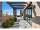 Covered patio with stone flooring, pergola, and desert landscaping at 10249 E Joy Ranch Rd, Scottsdale, AZ 85262