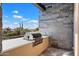 Built-in outdoor grill and countertop with desert views at 10249 E Joy Ranch Rd, Scottsdale, AZ 85262