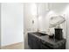 Modern powder room with dark stone sink, floating vanity, and textured wall art at 10249 E Joy Ranch Rd, Scottsdale, AZ 85262