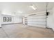 Spacious garage with polished concrete floor and large overhead door at 10249 E Joy Ranch Rd, Scottsdale, AZ 85262