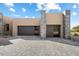 Modern home with two-car garage and stone accents at 10249 E Joy Ranch Rd, Scottsdale, AZ 85262