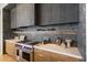 Modern kitchen with dark wood cabinets and a stainless steel range at 10249 E Joy Ranch Rd, Scottsdale, AZ 85262