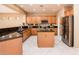 Spacious kitchen with island, stainless steel appliances, and granite counters at 13747 W Nogales Dr, Sun City West, AZ 85375