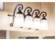 Elegant four-light vanity fixture with frosted glass shades at 13747 W Nogales Dr, Sun City West, AZ 85375