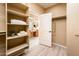 Ample walk-in closet with shelves and rods, plus bathroom access at 13747 W Nogales Dr, Sun City West, AZ 85375