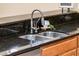 Modern kitchen sink with stainless steel double basin and granite countertop at 13747 W Nogales Dr, Sun City West, AZ 85375