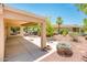 Covered patio, mature trees, and desert landscaping at 13747 W Nogales Dr, Sun City West, AZ 85375