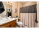 Clean bathroom with wood vanity and shower/tub combo at 13747 W Nogales Dr, Sun City West, AZ 85375