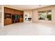 Living room with built-in entertainment center and backyard view at 13747 W Nogales Dr, Sun City West, AZ 85375