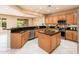 Island kitchen with granite countertops and wood cabinets at 13747 W Nogales Dr, Sun City West, AZ 85375